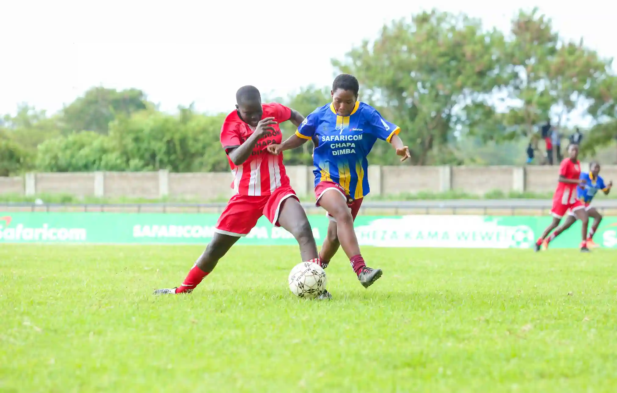 VSA’s Mweri Rehema (Right) goes for the ball as she gets shielded during the Safaricom Chapa Dimba Nyanza region Inter-County playoffs at Raila Odinga Stadium in Homa Bay.