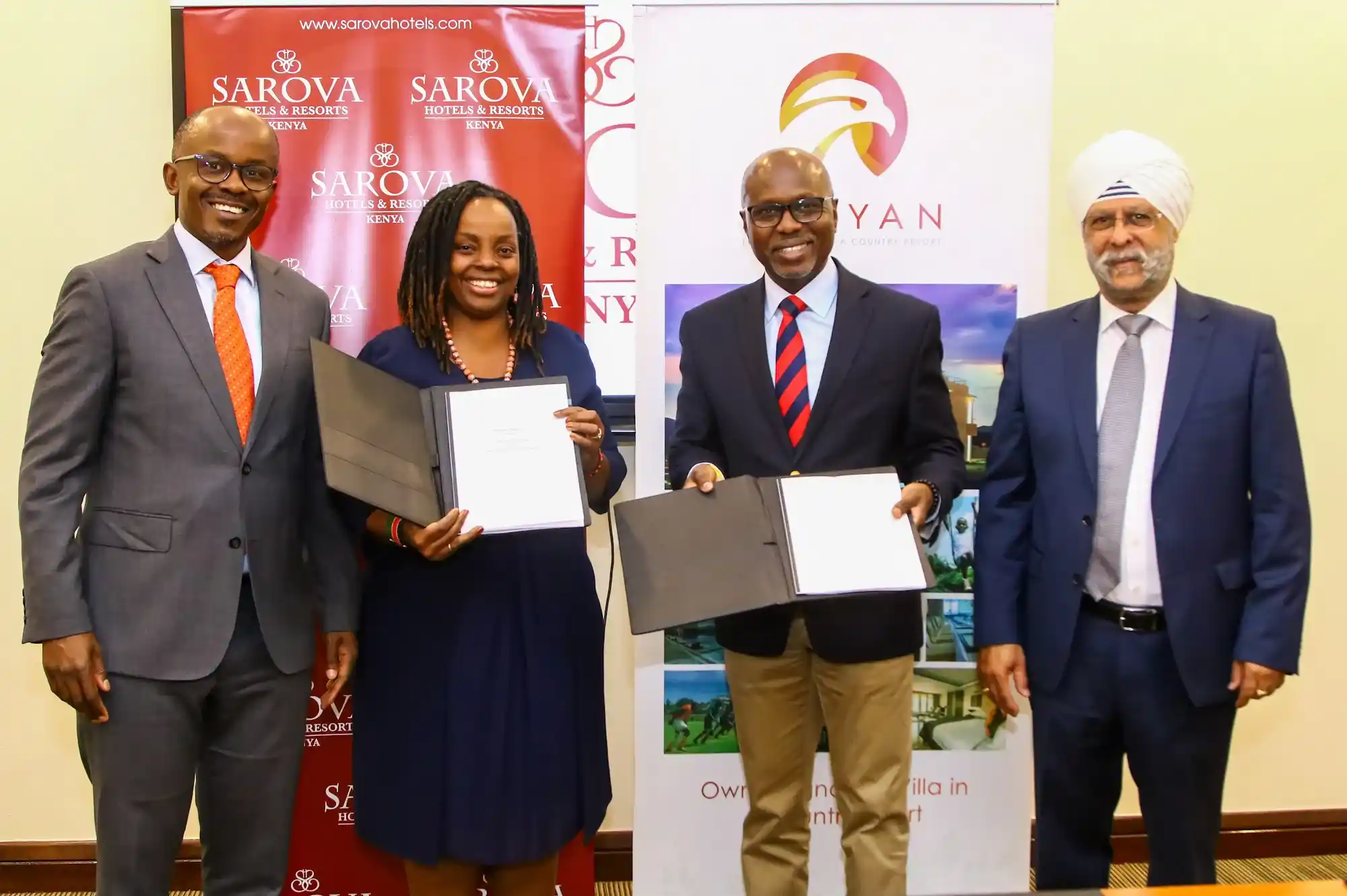 Sarova Hotels Group Managing Director, Jimi Kariuki (second right) and Maiyan Luxury Resort Director Joan Mworia (second left), exchange signed copies of the franchise agreement that will see Maiyan Resort rebranding to Sarova Maiyan Nanyuki, and becoming the ninth hotel under Sarova Hotels Group. Joining the two executives to commemorate the new partnership are Maiyan Luxury Resort Chairman James Mworia (left) and Sarova Hotels Finance Director Jagjit Ahluwalia (right).