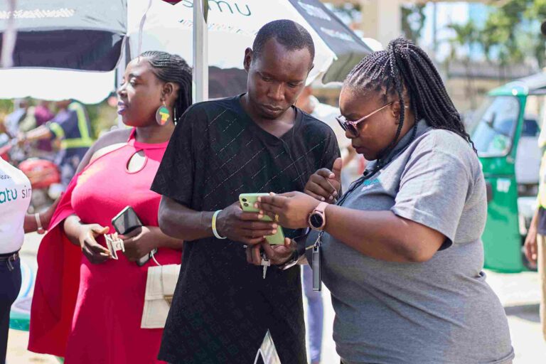 Watu Credit staff assisting customers with smartphone financing