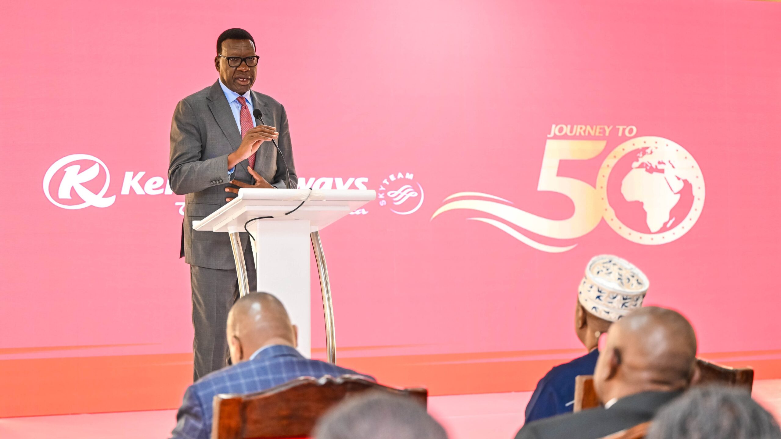 Cabinet Secretary Davis Chirchir addressing guests at a podium during Kenya Airways' Journey to 50 event