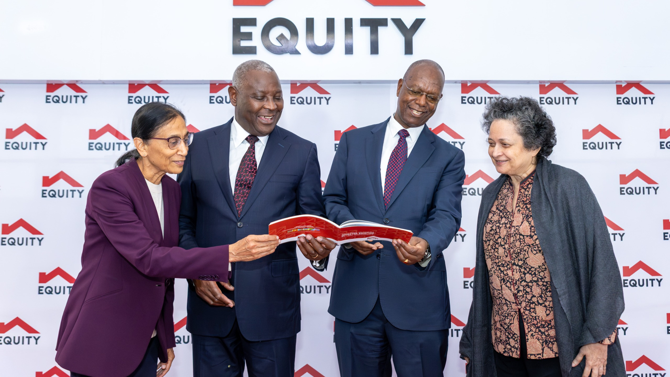 Equity Group leadership including Dr. Lakshmi Shyam-Sunder, Dr. James Mwangi, Prof. Isaac Macharia, and Ms. Farida Khambata reviewing a document at the H1 2026 Investor Briefing.
