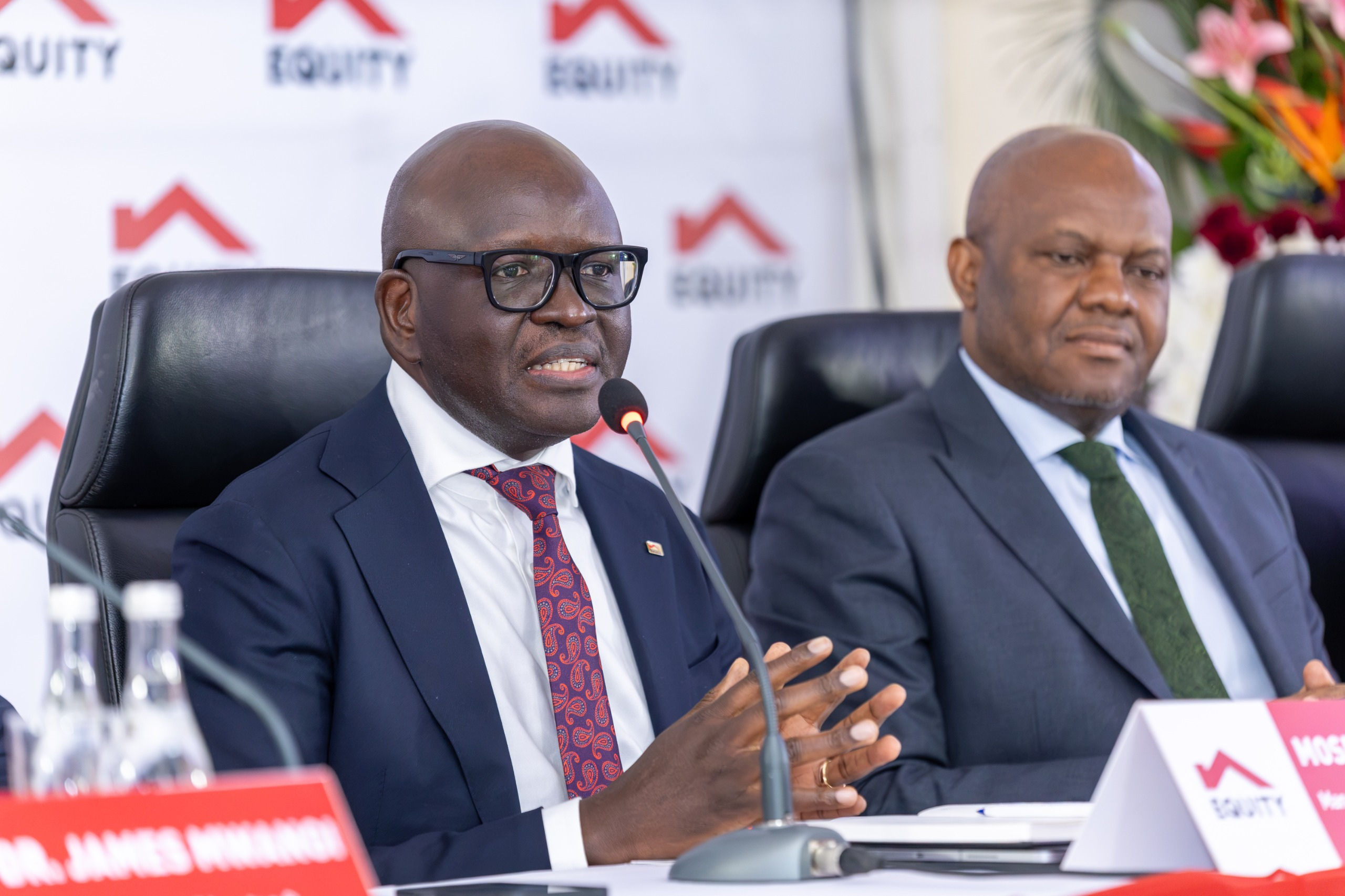Willy Mulamba, Managing Director of Equity BCDC, speaking beside Moses Nyabanda of Equity Bank Kenya at the investor briefing