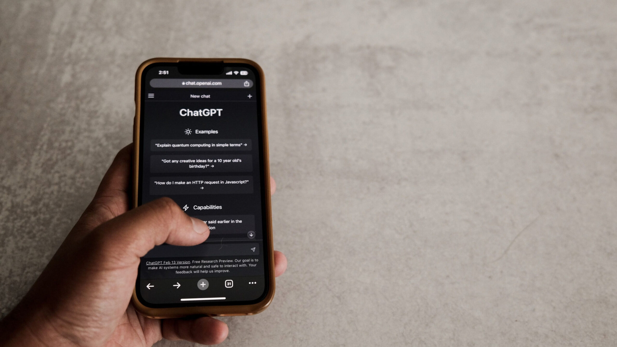 Close-up of a hand interacting with ChatGPT on a smartphone, showcasing modern AI technology.
