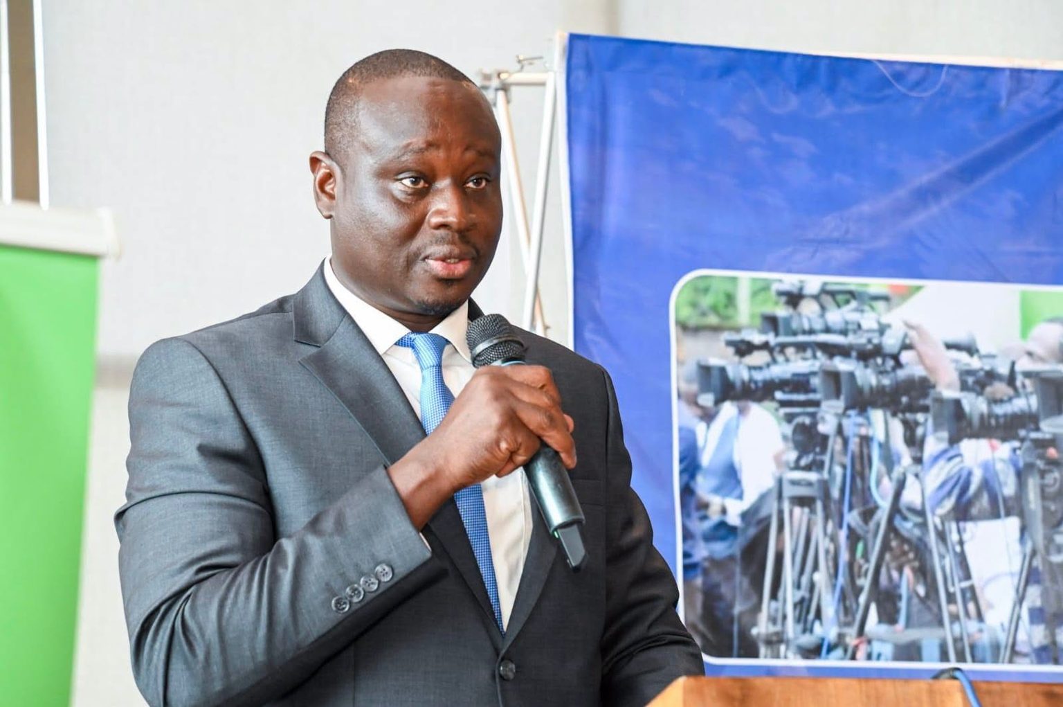 KUJ Secretary General Erick Oduor speaks into a microphone at a podium in Nairobi