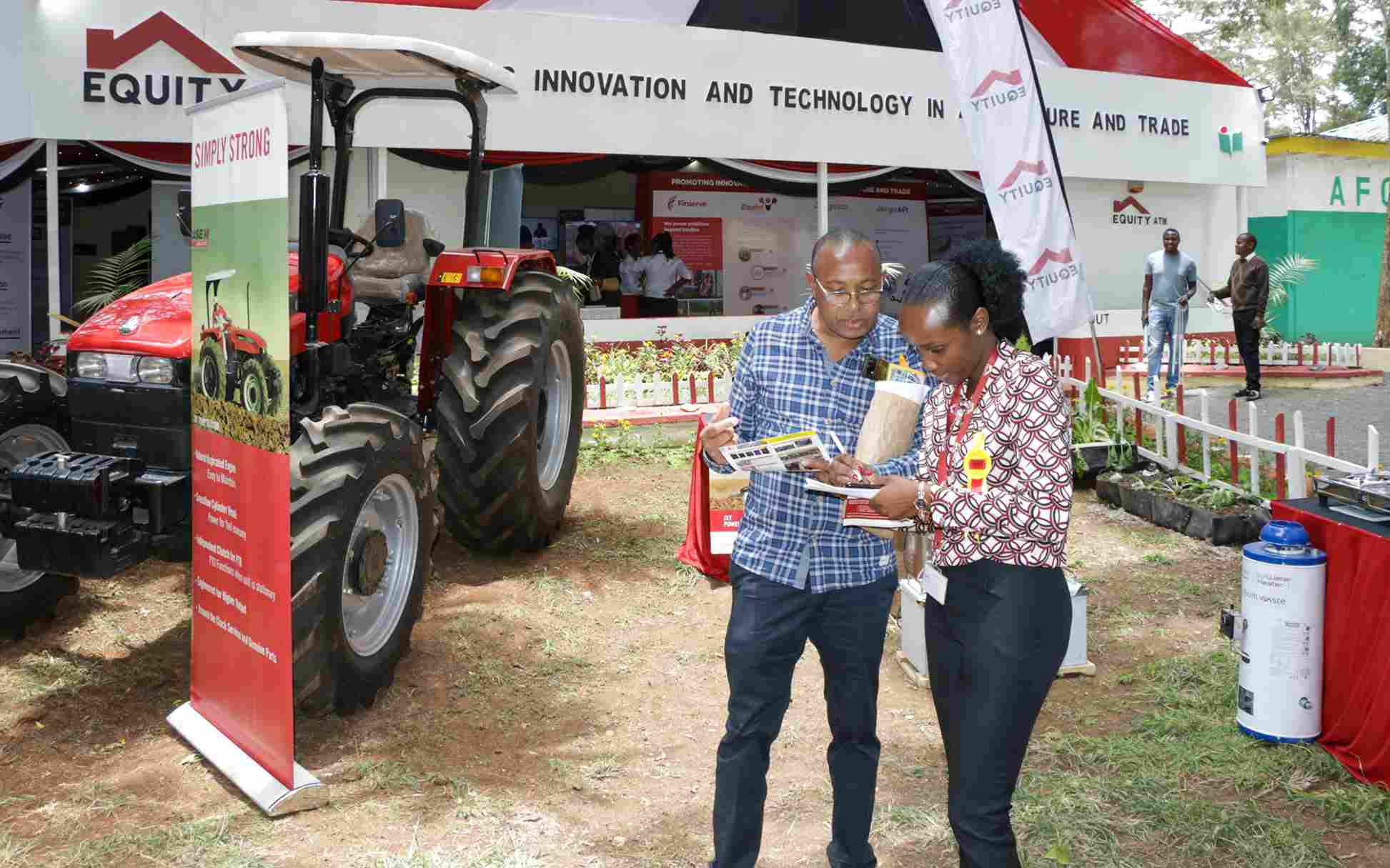 Equity Group Foundation Energy and Environment Officer Mary Mwangangi (right) engages with an Agriculture Society of Kenya Nairobi Show attendee on Equity’s clean energy solutions for farmers.