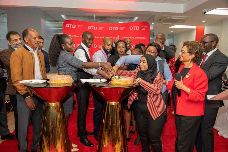 Nasim Devji, the Group CEO-Diamond Trust Bank (DTB) leads the DTB Staff in cake cutting during the DTB Sarit Centre Branch opening at Westlands in Nairobi.