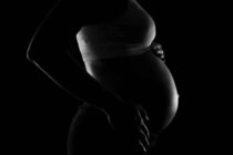 Gray scale Photo of a Pregnant Woman. In Kenya, teenage pregnancy and motherhood rates have remained unchanged since 2008.