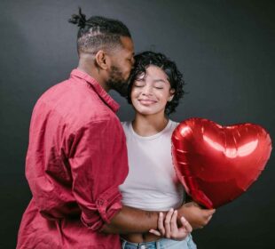 Couple Kissing While Holding a Red Heart Shaped Balloon one of the knowing who your partner is is .