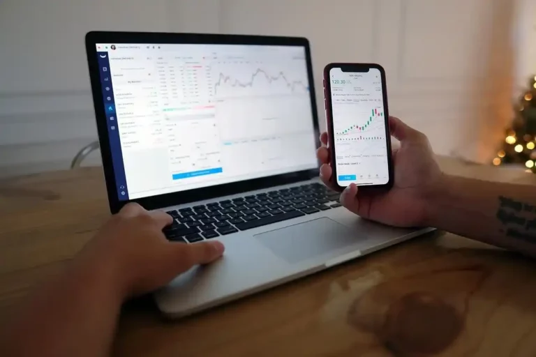 A person holding a phone checking forex trading