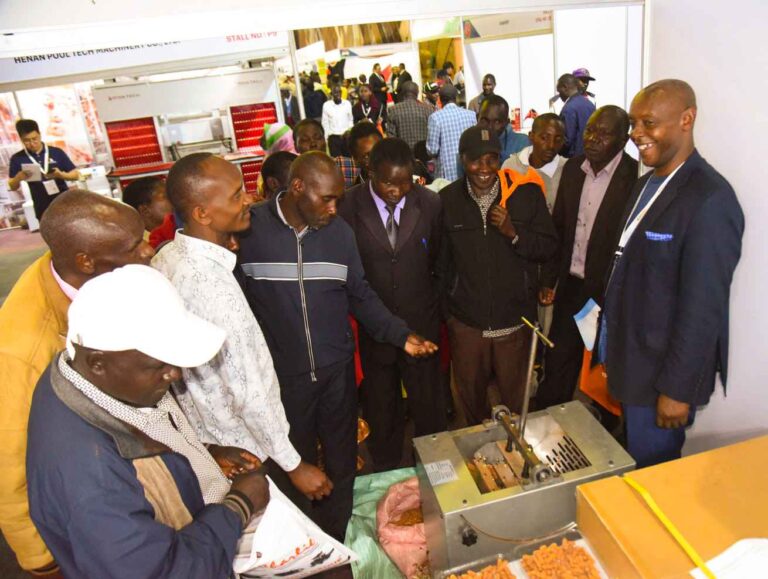 Banseok Industry Company Ltd Country Director, Mr Fredrick Kimani (Right) explains to attendees of the event how the peanut peeling machine works.