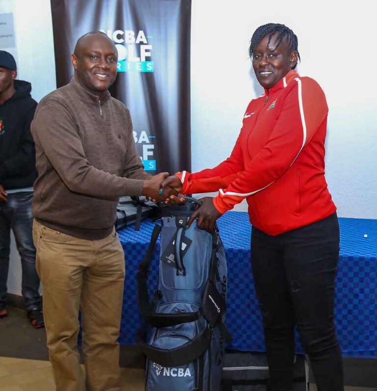 NCBA Branch Manager Thika, Julius Kareithi, presents an award to the Overall Winner, Valine Akoth who scored 43 Points during the NCBA sponsored Golf Mug event at Thika Barracks Golf Club.
