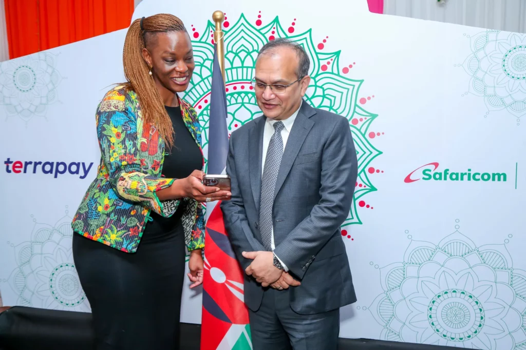 Esther Waititu(R) Chief Financial Services Officer Safaricom PLC Shows how the M-pesa App operates to Ambar Sur(L) Founder & Chief Executive Officer TerraPay this was after the official launch of the partnership between the two. Michael Joseph Center in Nairobi, Kenya, served as the venue for the event.