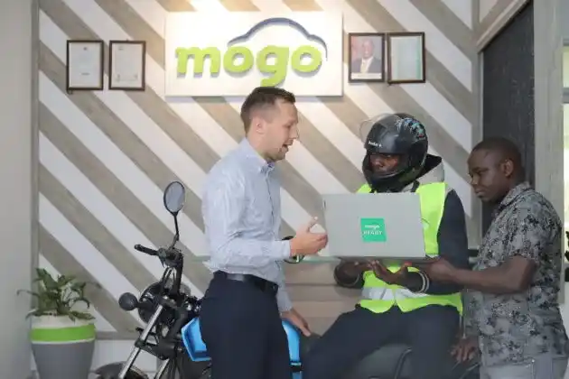From Left: MOGO Kenya country manager Domas Mineikis, Boda Boda operator Elijah Kambati and MOGO’s head of underwriting Chris Murimi during the launch of the financial literacy too