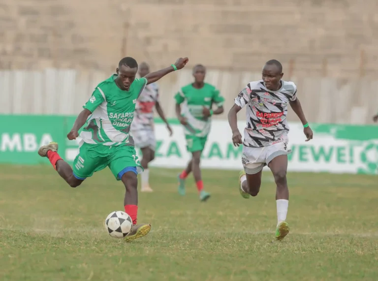 FIan Itenje of Ibwali boys drible the ball past Alfred Lutta of The Menace during the regional Safaricom Chapa Dimba Western Region semifinal at Bukhungu stadium today. The match ended 3-2 in favor of Ebwali boys.