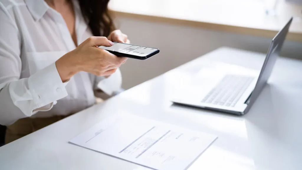 A woman scanning a page with an Optical Character Recognition