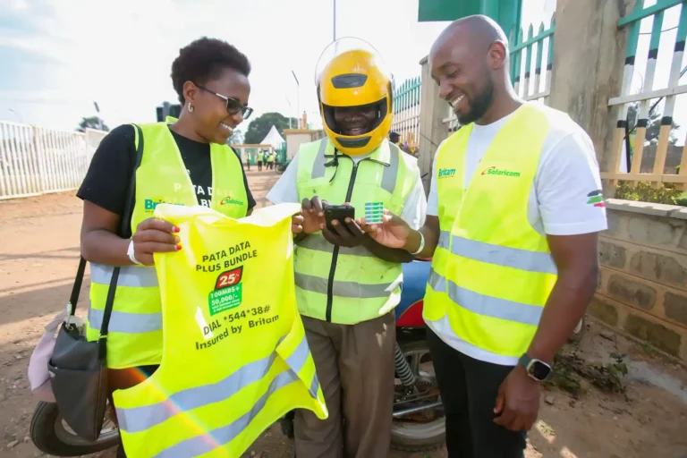 David Odhiambo, a boda boda rider, is shown how to register the data plus bundles and is informed of the benefits by Evah Kimani (L), Director of Partnerships and Digital at Britam, and Gideon Karimi (R), Head of Mobile Data at Safaricom.