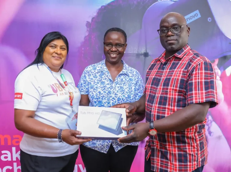 Jane Govindsamy, CSI Champion, Lenovo South Africa, (left), Dorcas Wepukulu - Partner Development Coordinator African Storybook, SAIDE (centre) and Sitima Colly - Librarian in Charge, Kibera County Library (right) try out a new tablet, during a CSR activity by Lenovo at Kibera County Library.