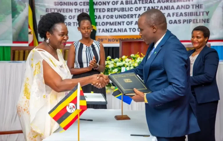 Deputy Prime Minister Doto Biteko and Uganda's Minister of Energy and Mineral Development, Ruth Nankabirwa (left), signing a bilateral Agreement between Tanzania and Uganda in the implementation of the Construction of the Natural Gas Pipeline Project from Tanzania to Uganda.