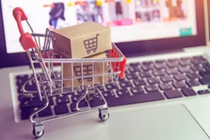 Parcel or Paper cartons with an online shopping cart logo in a trolley on a laptop keyboard. Explore African e-commerce growth drivers, challenges, and future potential, including mobile payments, AI integration, and AfCFTA impact.