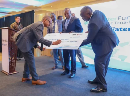 Eric Kiniti, Group Corporate Relations Director – EABL signs a cheque for Ksh 60 million during an event with stakeholders ahead of World Water Day celebrations on March 22. Looking on (R to L) on is Mr. Julius Korir, CBS, Principal Secretary, Ministry of Water, Sanitation and Irrigation, Eddy Njoroge, President, Upper Tana Nairobi Water Fund Trust (UTNWFT) and Laikipia Governor, Joshua Irungu.
