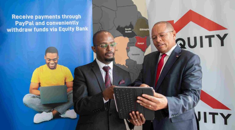 Equity Bank Kenya Managing Director Gerald Warui (right) and Equity Group General Manager, International Banking and Cross Border Payments Andrew Kabeke (left) discuss the instant PayPal withdrawal service available on Equity Mobile App and Equity Online. Equity has enhanced PayPal withdrawals from the initial 24-hour withdrawal period to an instant withdrawal capability.