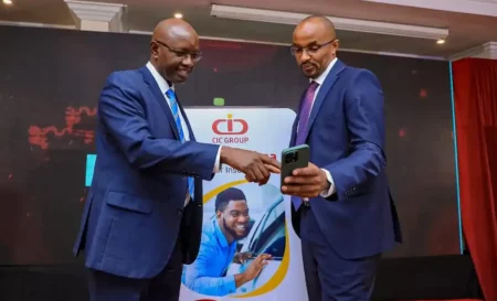 CIC Group CEO Mr Patrick Nyaga (left) and Managing Director General Business Mr Fred Ruoro (right) during their digital monthly motor insurance cover launch, Easy Bima, in Nairobi.