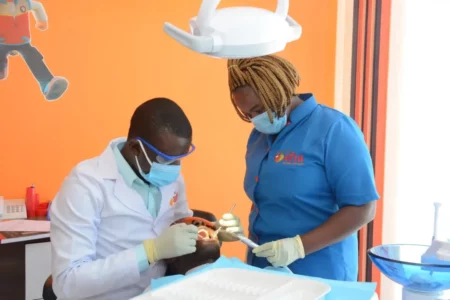 Equity Afia Langata Dental Technologist Patrick Onyango (left) and Dental Assistant Marion Chege (right) attend to a client. Equity Afia offers general dental services and restorative procedures such as fillings, root canals, and periodontal treatment