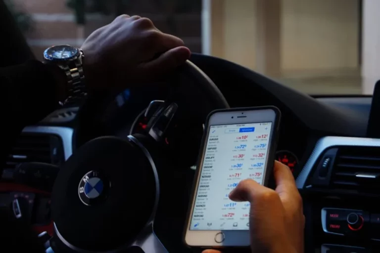 Man holding smartphone for trading