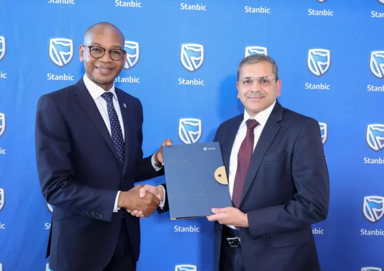 Dr. Joshua Oigara, Chief Executive, Stanbic Bank Kenya and South Sudan exchange documents with Anoop Gala, Global Head of Financial Services, Orion Innovation during a software agreement signing ceremony to upgrade Stanbic Bank Kenya's core banking system to the latest Temenos 24