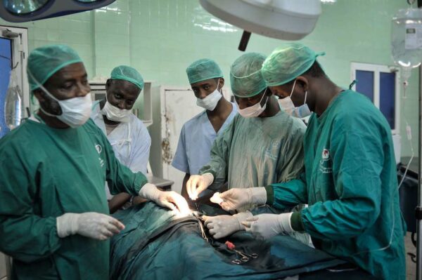 Surgeons stitch up a patient after an operation at Banadir hospital in Mogadishu, Somalia, on February 4. AU UN IST PHOTO / Tobin Jones