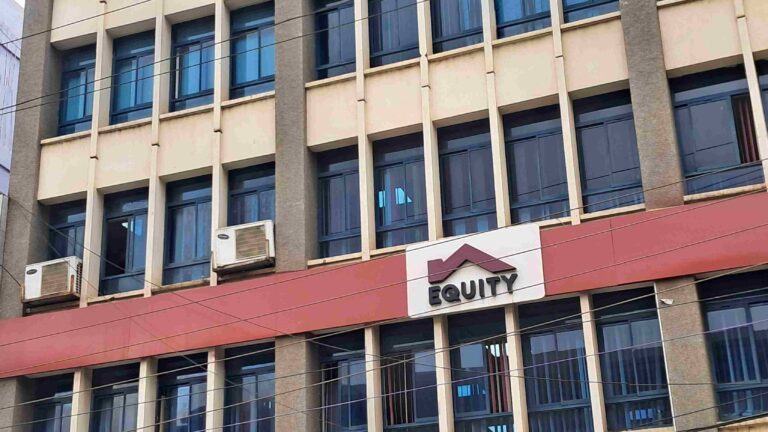 A multi-story building with a sign that reads "EQUITY" and features a logo of a house with a maroon roof.