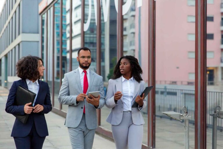 Business colleagues walking and talking on street