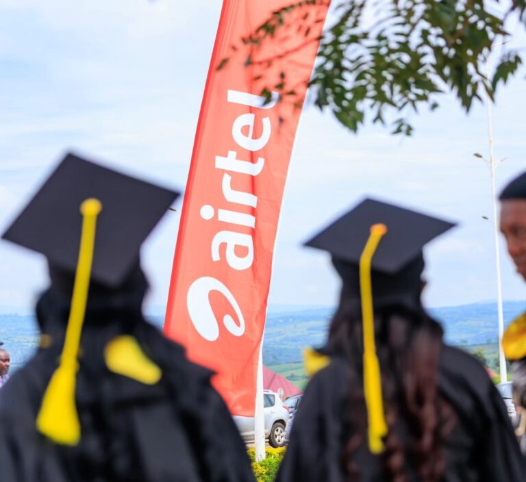 Airtel Africa, Nokia Expand Fiber Network Across East and Central Africa Graduates in colorful academic gowns stand near an Airtel Rwanda banner at East African University Rwanda’s outdoor graduation ceremony.