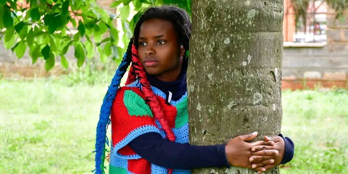 Truphena Muthoni: Kenya’s New Face of Green Activism Truphena Muthoni hugging a tree during her Guinness World Record attempt in Nyeri, Kenya.