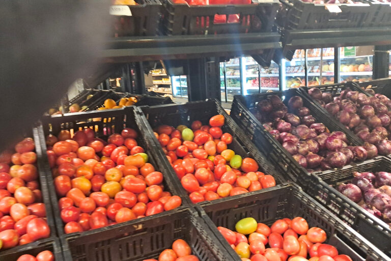 Crates of fresh tomatoes and red onions on display at a Kenyan grocery store, reflecting rising food prices recorded in the March 2026 KNBS inflation report