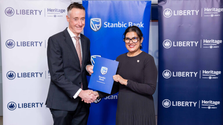 Kieran Godden, Group CEO of Liberty Kenya Holdings, and Anjali Harkoo, Head of Insurance and Asset Management at Stanbic Bank Kenya, signing a Vehicle and Asset Financing insurance partnership agreement.