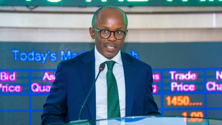 Petition filed against Mworia’s appointment as Infrastructure Fund CEO James Mworia, CEO of Centum Investment Company, speaking at a podium in front of a stock market ticker display.