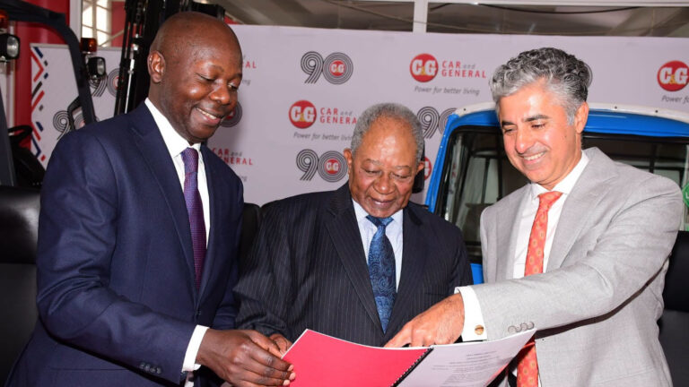 Car & General Profit Triples On Watu Associate Gains Nicholas Ng'ang'a, Conrad Nyukuri and Vijay Gidoomal review a document at a Car & General event