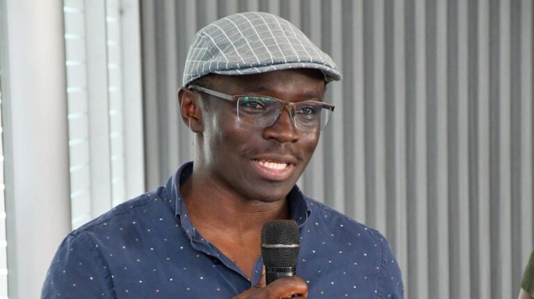 Otieno Steps Down As Baraza Media Lab Director Maurice Otieno speaking into a microphone at a media event