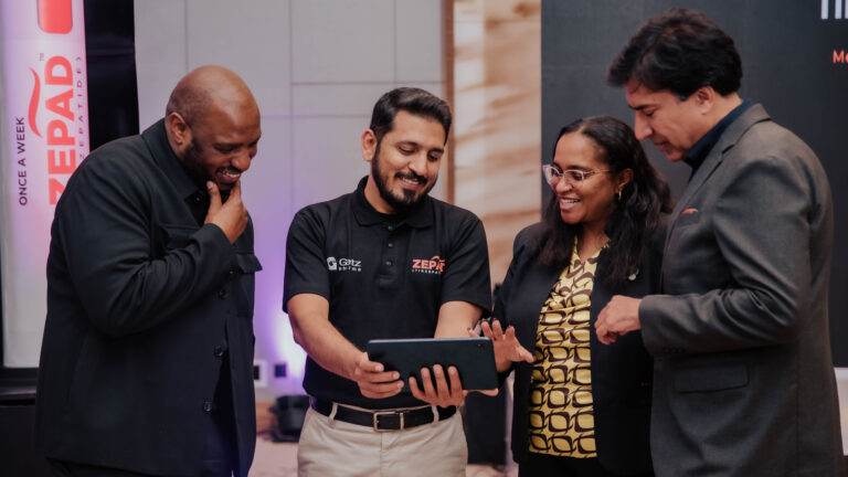 Kenya’s Metabolic Disease Crisis Hides in Plain Sight Dr Erick Njenga, Muhammad Ashad, Dr Rosslyn Ngugi, and Prof Abbas Raza view a tablet together at the Convergence metabolic disease forum in Nairobi, with a Zepad tirzepatide banner in the background.