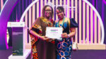 Marina Kamanzi, founder of Kagezi Seed Company, holds her WAYA 2026 Grand Prize certificate at the Africa Food Systems Forum in Kigali.