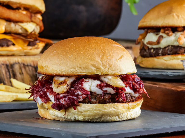 Nairobi Burger Week Returns, and the Data Behind It Reveals How the City Really Eats A close up of gourmet burgers with melted cheese, onion rings and fries, styled for Nairobi Burger Week 2026.