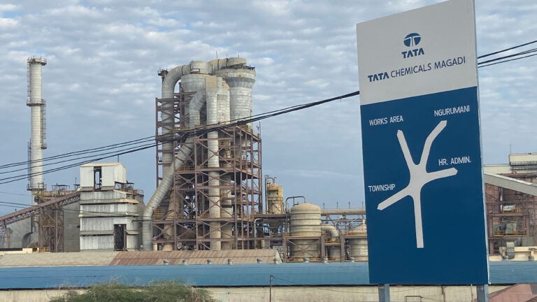 Ruto Orders Tata Chemicals Out Of Magadi, Names Replacement Investor Tata Chemicals Magadi entrance sign with the soda ash processing plant and industrial towers in the background, Kajiado County, Kenya