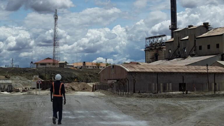 Kenya Forms Technical Team to Resolve Tata Chemicals Magadi Dispute Tata Chemicals Magadi soda ash plant with a worker in safety gear walking toward the site in Kajiado County, Kenya.