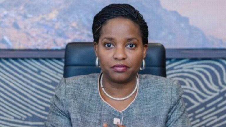 Anne Juuko Takes Over as EADB Director General Anne Juuko, Director General of the East African Development Bank, seated at a desk with her hands pressed together.