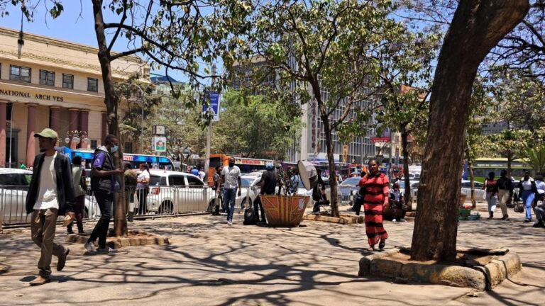 Kenya Inflation Rises to 6.8 Percent in September Pedestrians walk past street vendors and parked cars outside the Kenya National Archives in Nairobi.