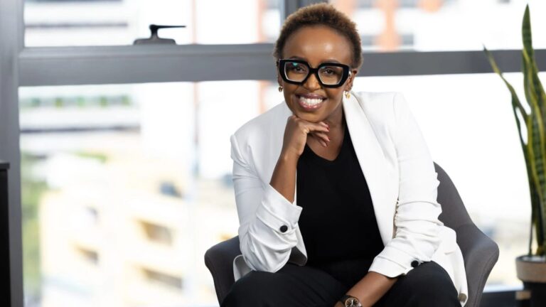 Heritage MD Rosalyn Mugoh Elected KWIIN Vice President Rosalyn Mugoh, Managing Director of Heritage Insurance, seated by a window in a white blazer with her hand under her chin.